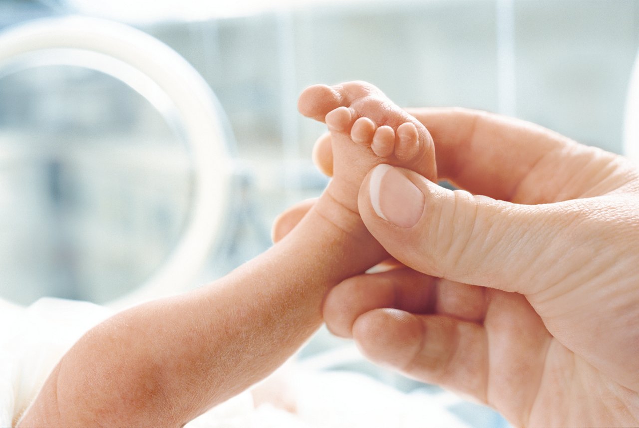 parent holding babys foot