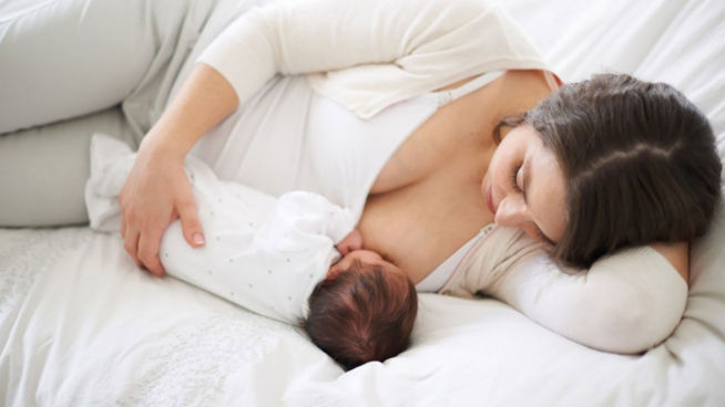 breastfeeding baby on bed 2