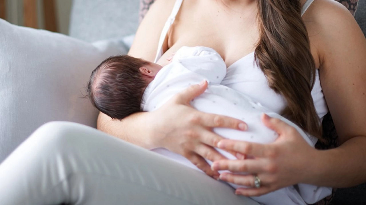 Dad holding son in kitchen