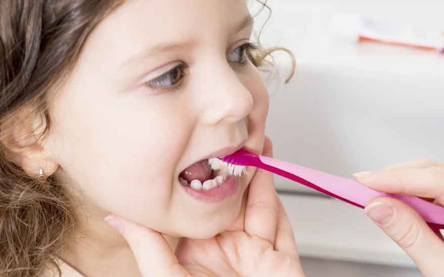 Gros plan sur des mains utilisant une pince a epiler rose pour se faire belle. La scene semble se derouler a l'interieur, peut-etre dans une salle de bain ou un coin coiffure, avec un fond blanc et neutre. L'accent est mis sur la pince a epiler et le geste de se faire belle, soulignant la precision et le soin apportes.