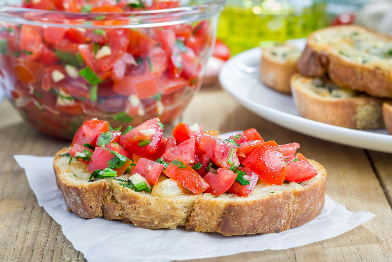 Bruschetta with tomatoes, herbs and oil on toasted garlic cheese bread