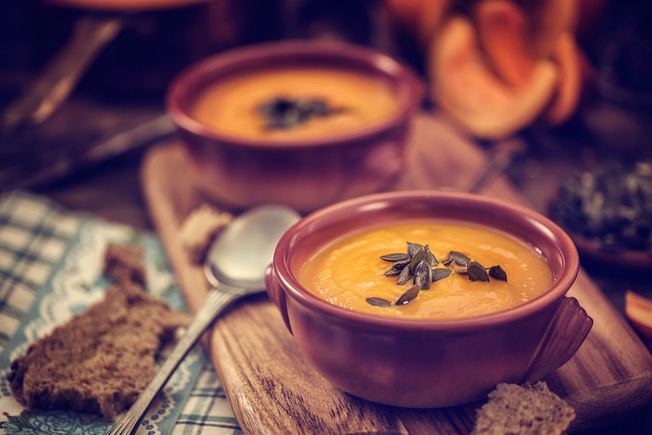 two bowls of butternut squash and red pepper soup