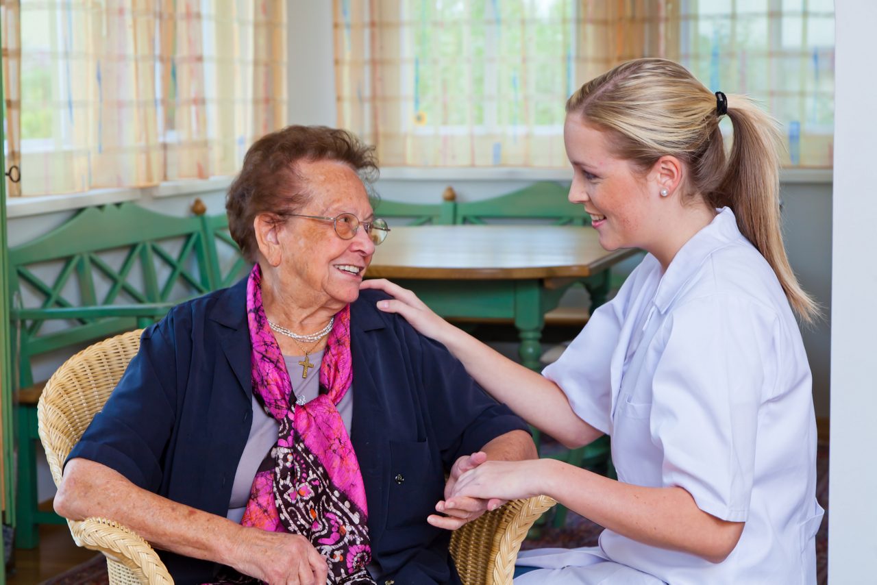 Nurse and elderly woman talking