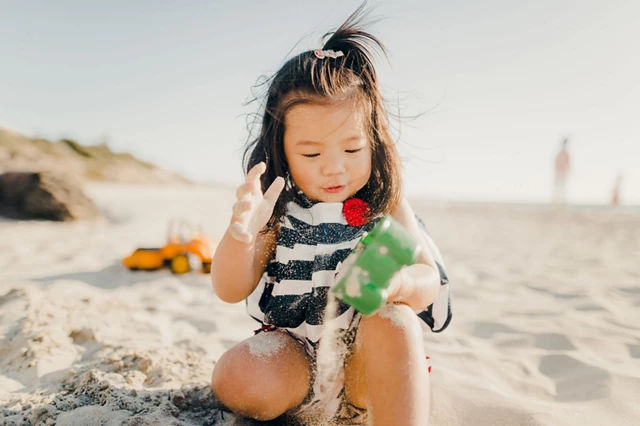 Girl playing at the beach