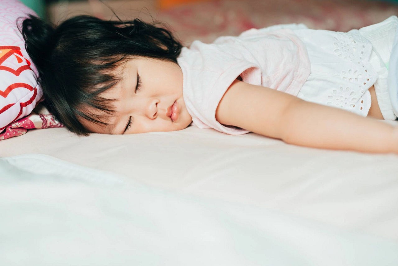 Little girl sleeping in pink