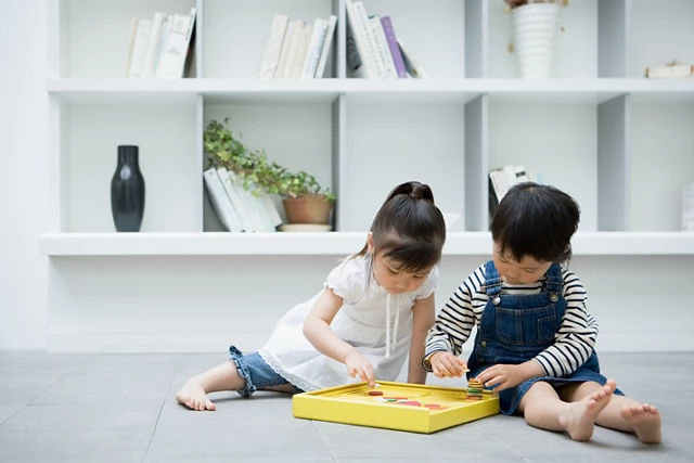 Boy and girl playing game at home