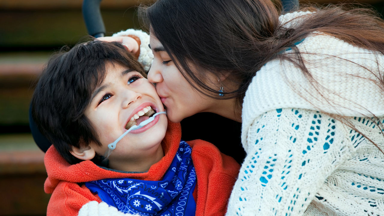 child-cerebral-palsy-smiles-with-sister.jpg