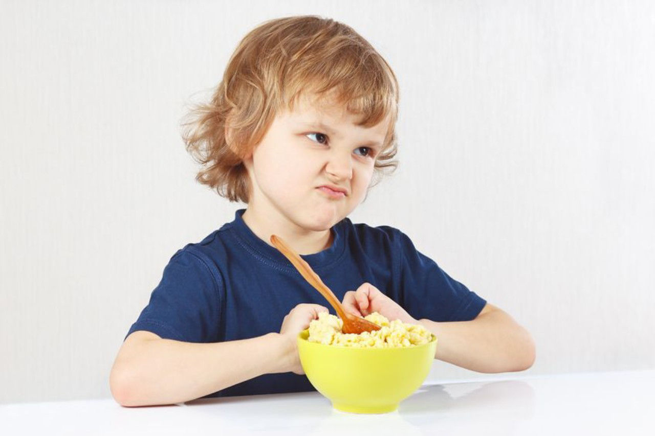 Toddler sitting at the table refusing food