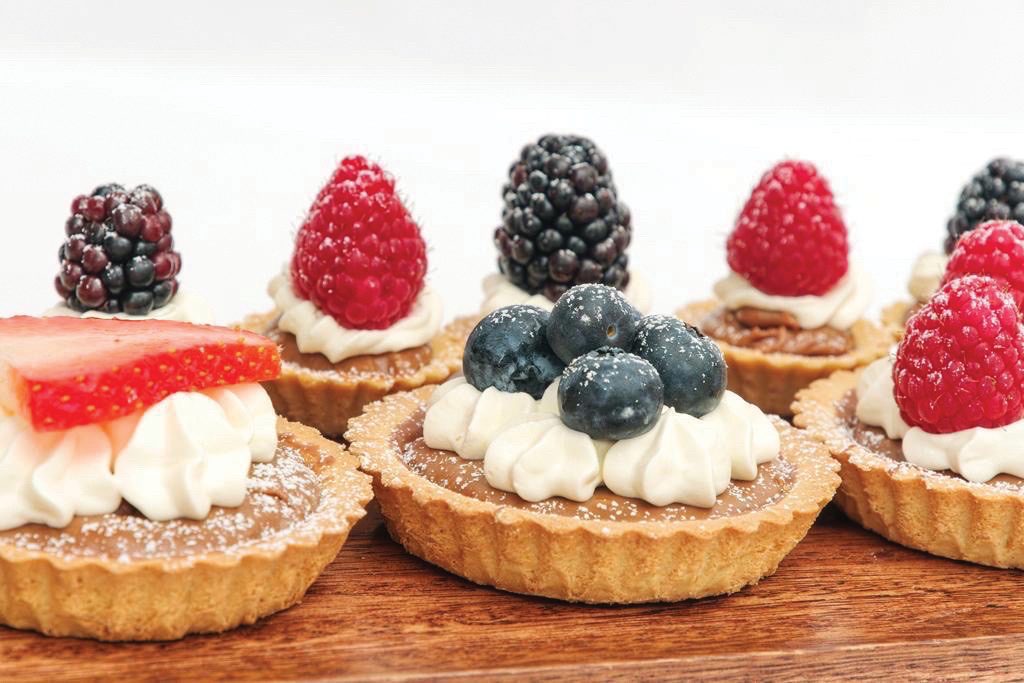 Chocolate caramel fruit tarts with fruit decorations 