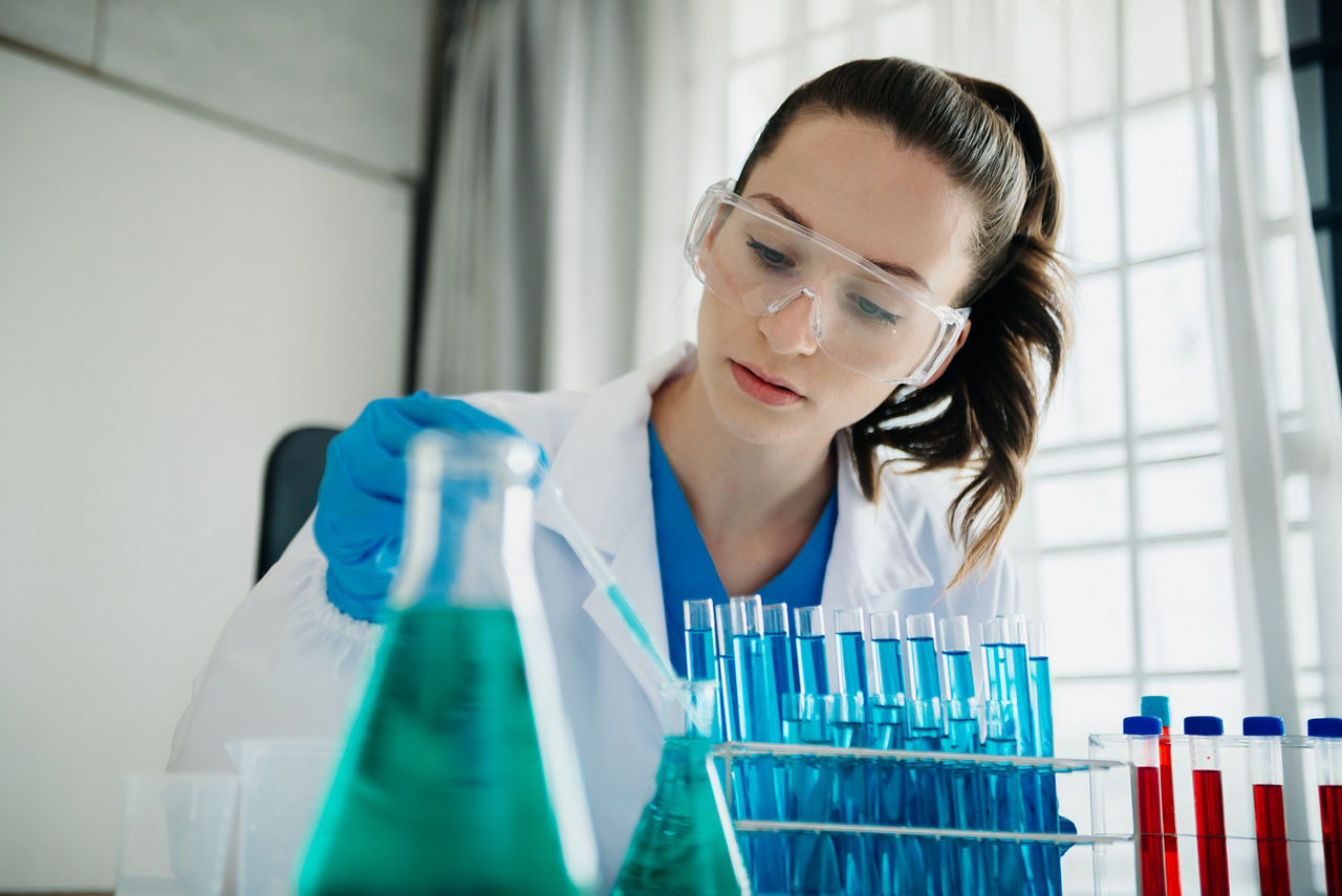 Modern medical research laboratory. female scientist working with micro pipettes analyzing biochemical samples, advanced science chemical laboratory