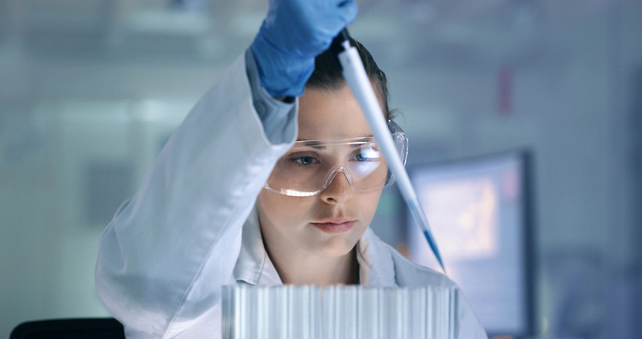 Doctor, scientist or medical expert doing a trial, experiment or test working in a science lab, hospital or clinic. Serious, concentrating and determined professional sorting and organizing samples