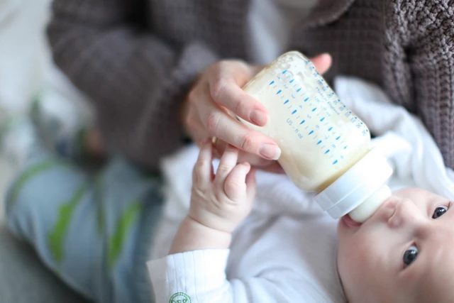 Breastfeeding baby on bed
