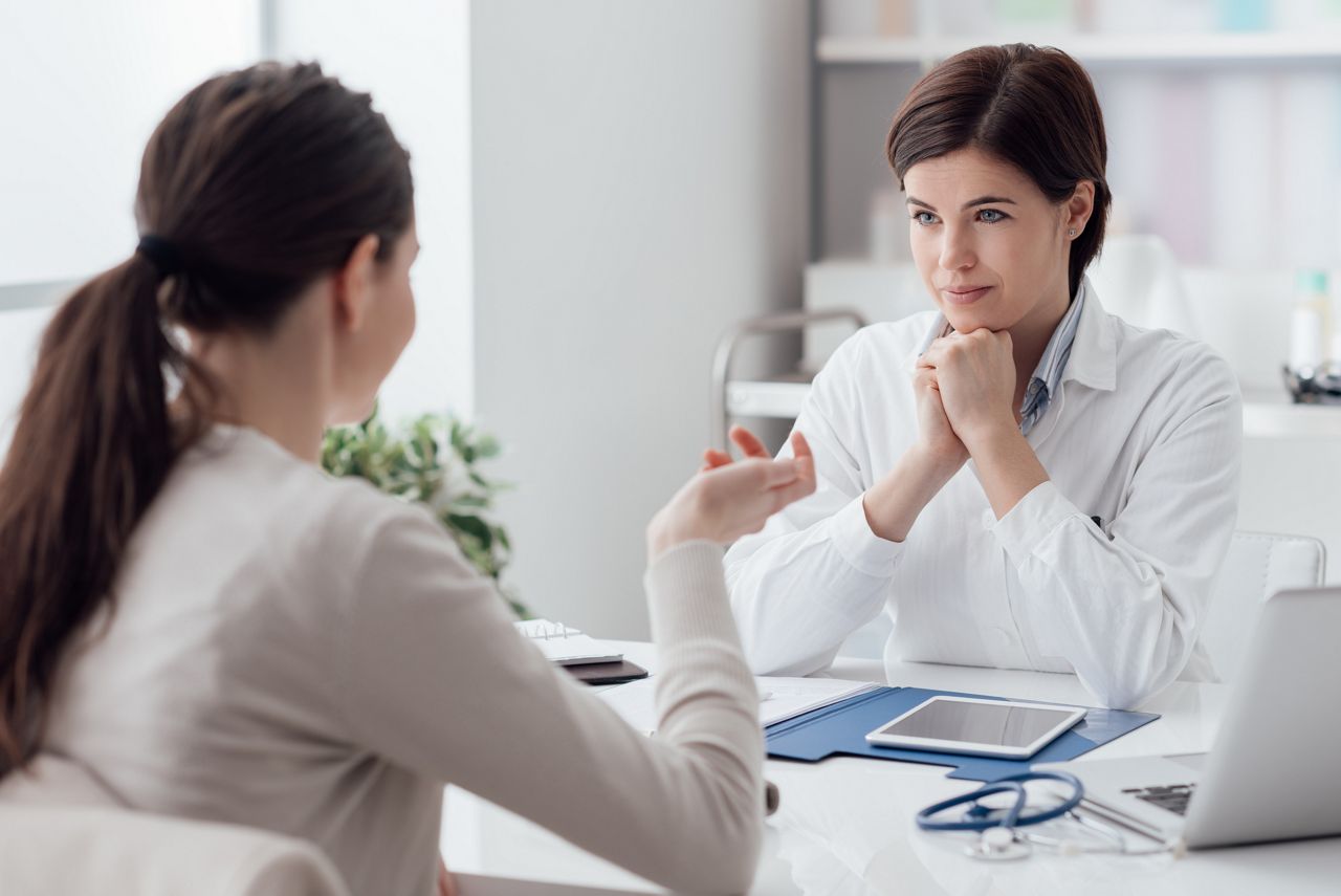 Doctor working in the office and listening to the patient, she is explaining her symptoms, healtcare and assistance concept