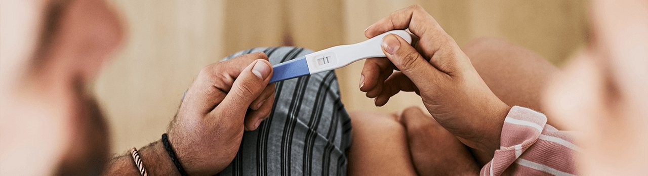 Couple holding positive pregnancy test