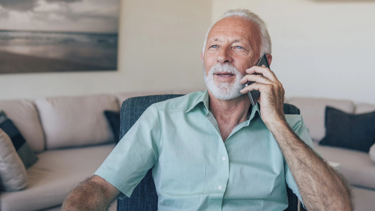 Elderly man speaking on a phone