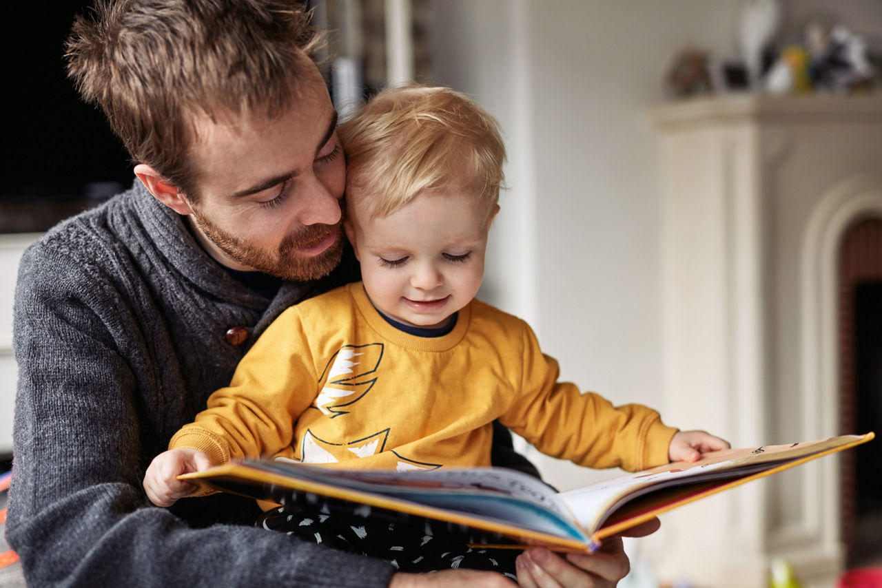 Father reading a book to his toddler