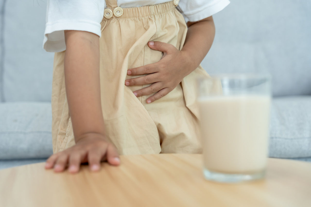 Milk allergens, children felling stomachache and diarrhea , runny stuffy sore nose suffer from intolerance allergy trigger symptoms. abdominal pain nut protein, rash, death, food allergy