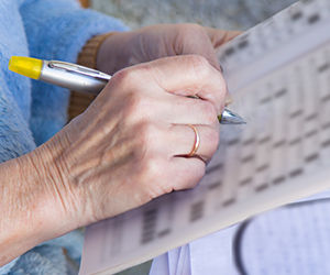 Person completing a crossword