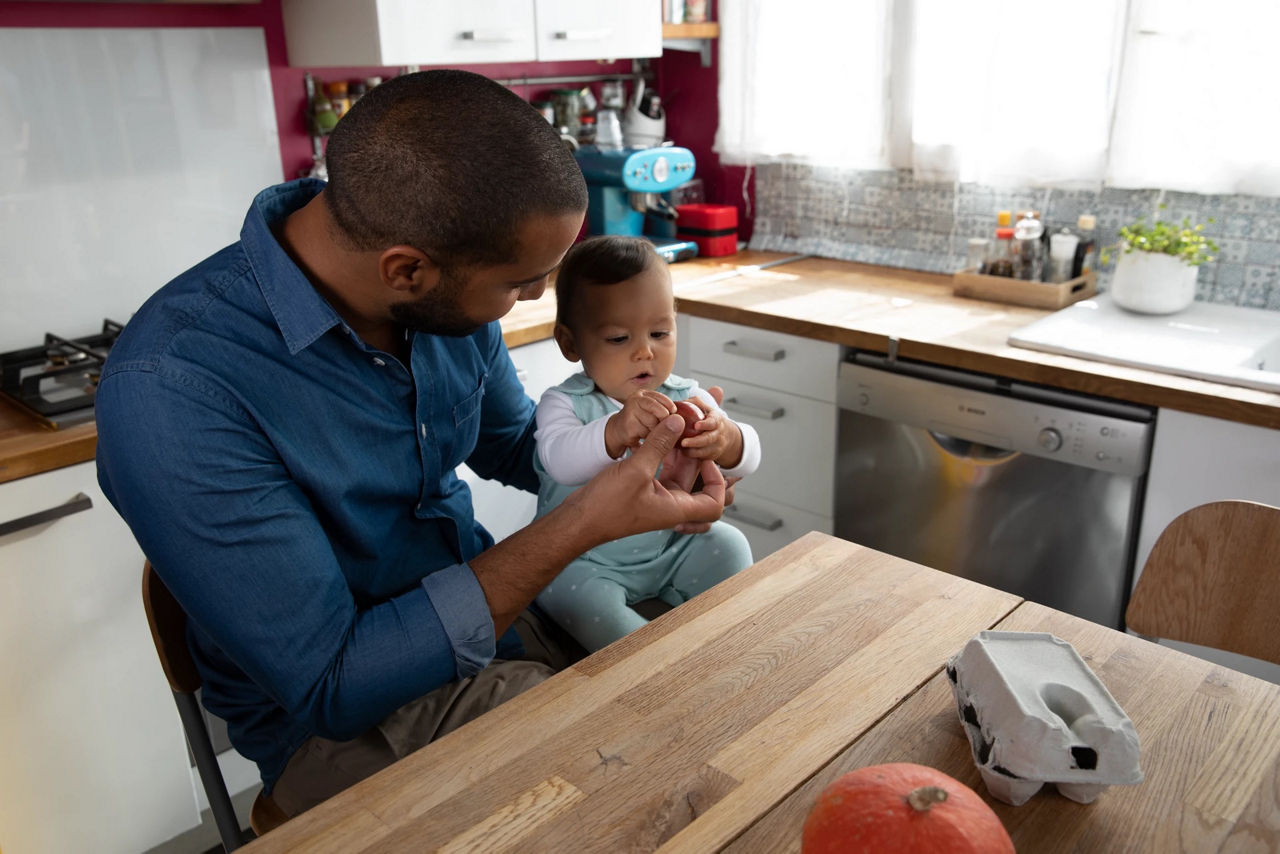 Dad baby in kitchen weaning