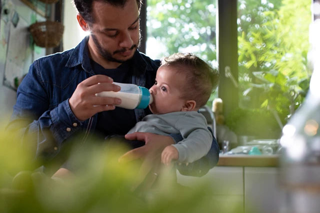 dad feeding baby