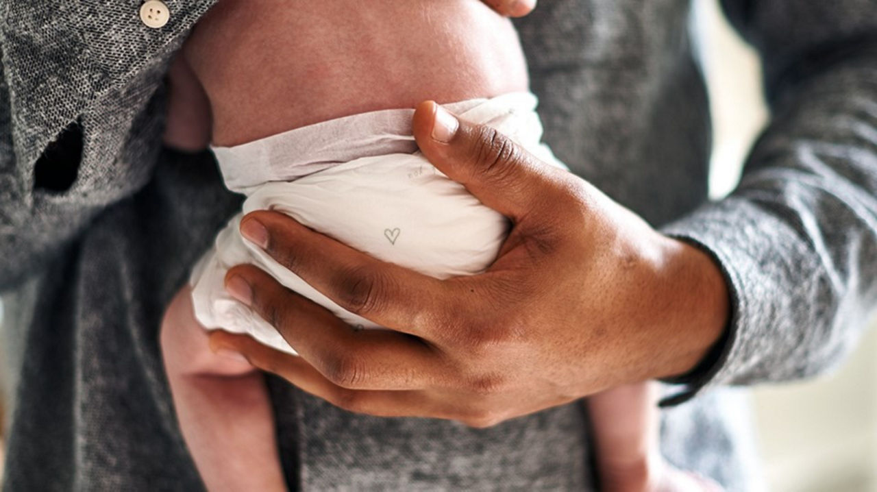 Dad holding newborn baby