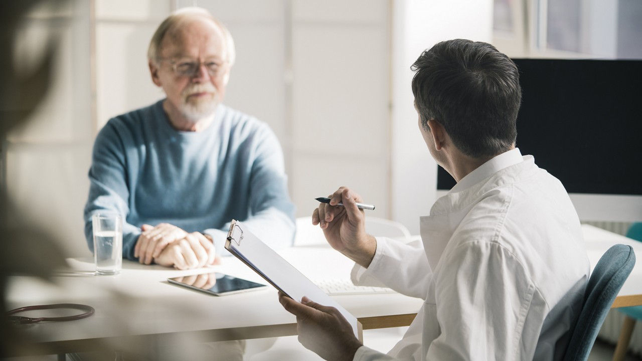 dr-and-clipboard-with-male-patient-during-consultation