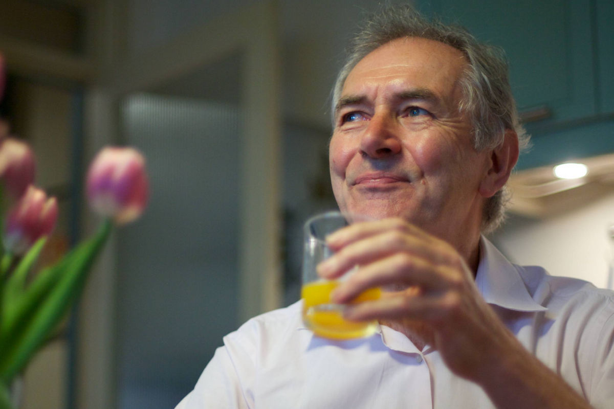 Man drinking a glass of orange juice