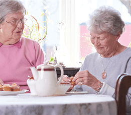 Elderly women having tea
