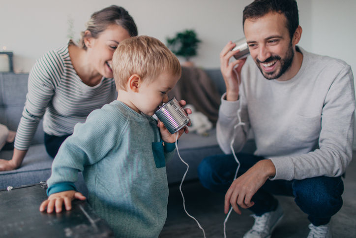 Photo of a young family using tin can telephone