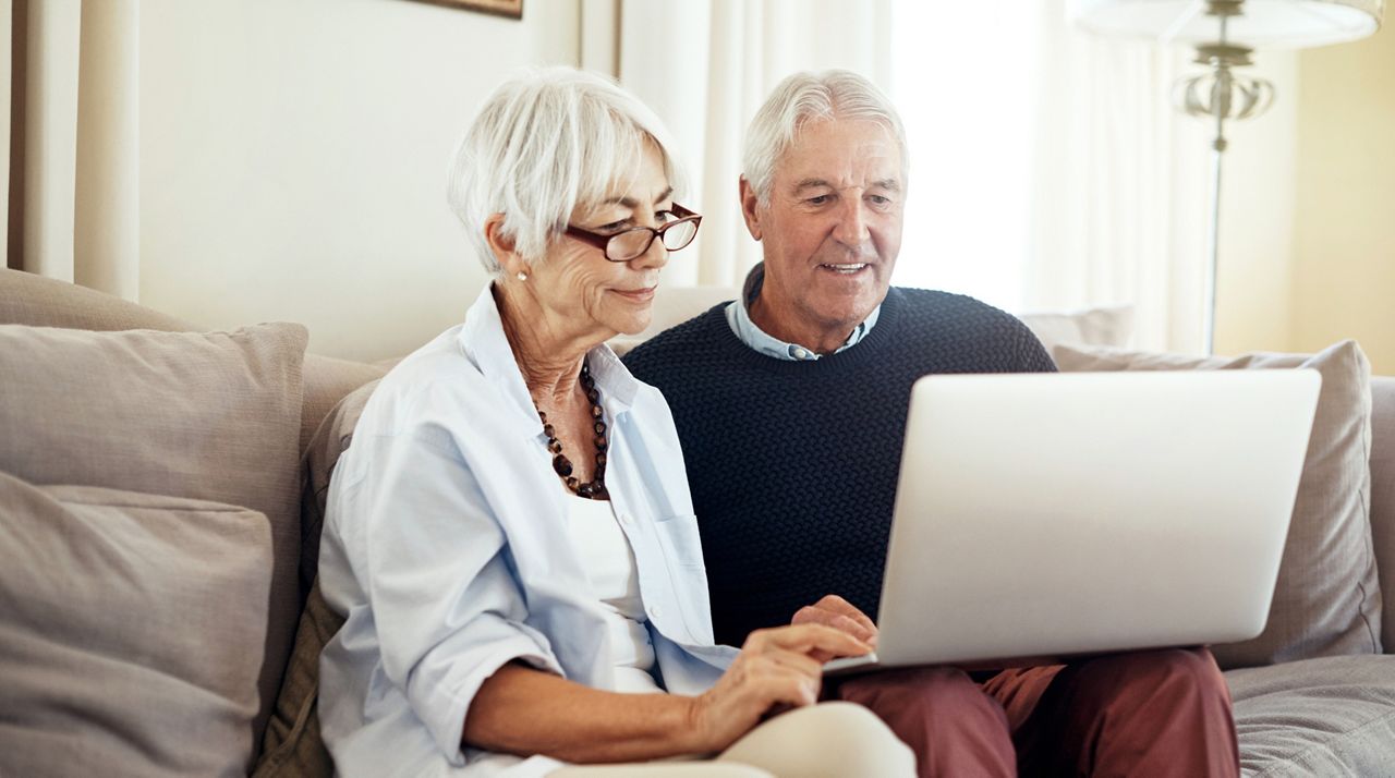 Shot of a senior couple using a laptop together at home