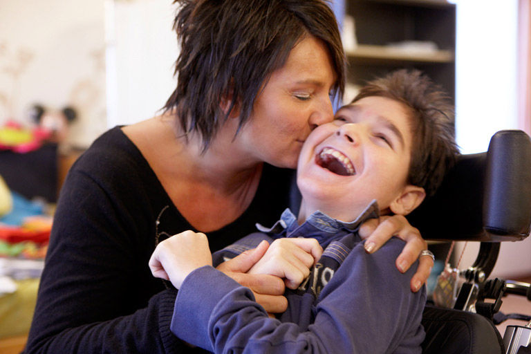 Mother kissing her child