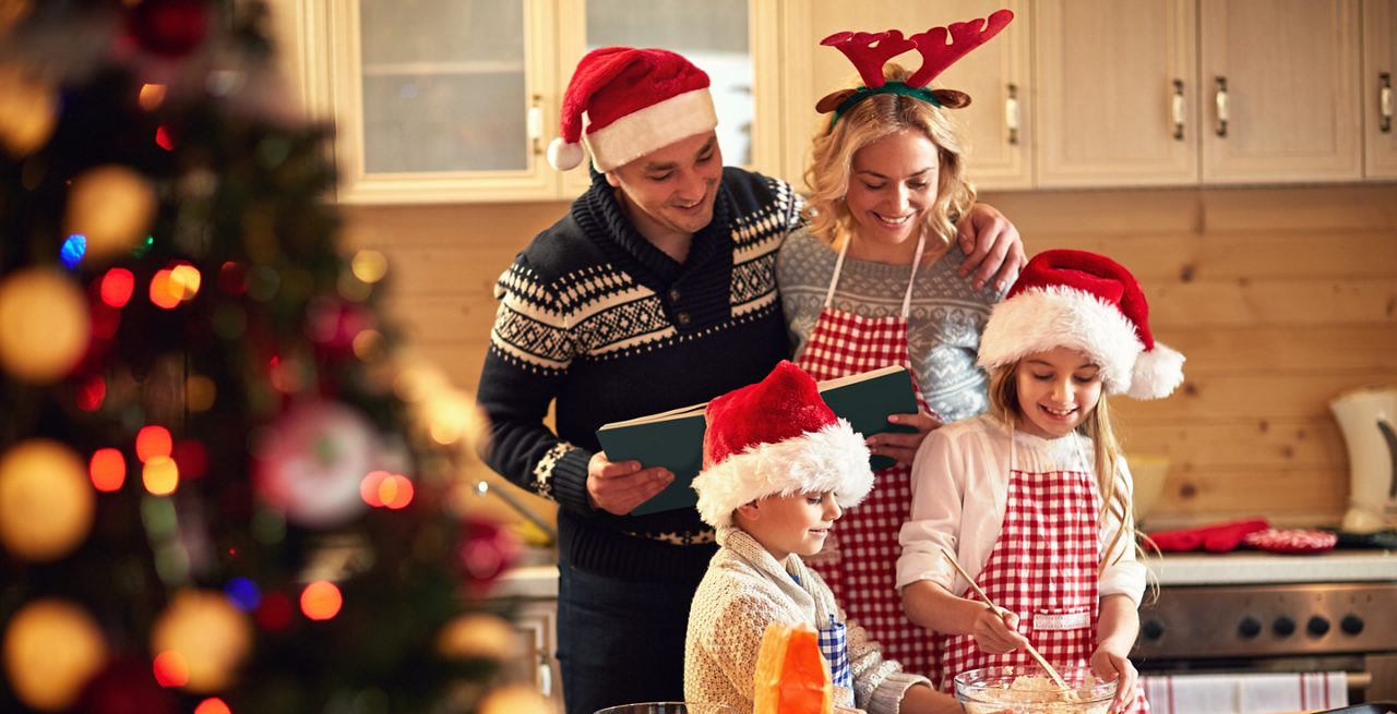 Top view of a dessert table with various pastries, sweets and a bouquet of fresh tulips.