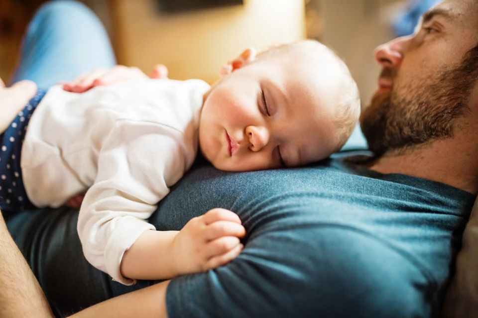 father with sleeping baby 