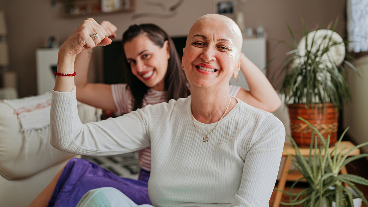 female-cancer-patient-flexing-arm