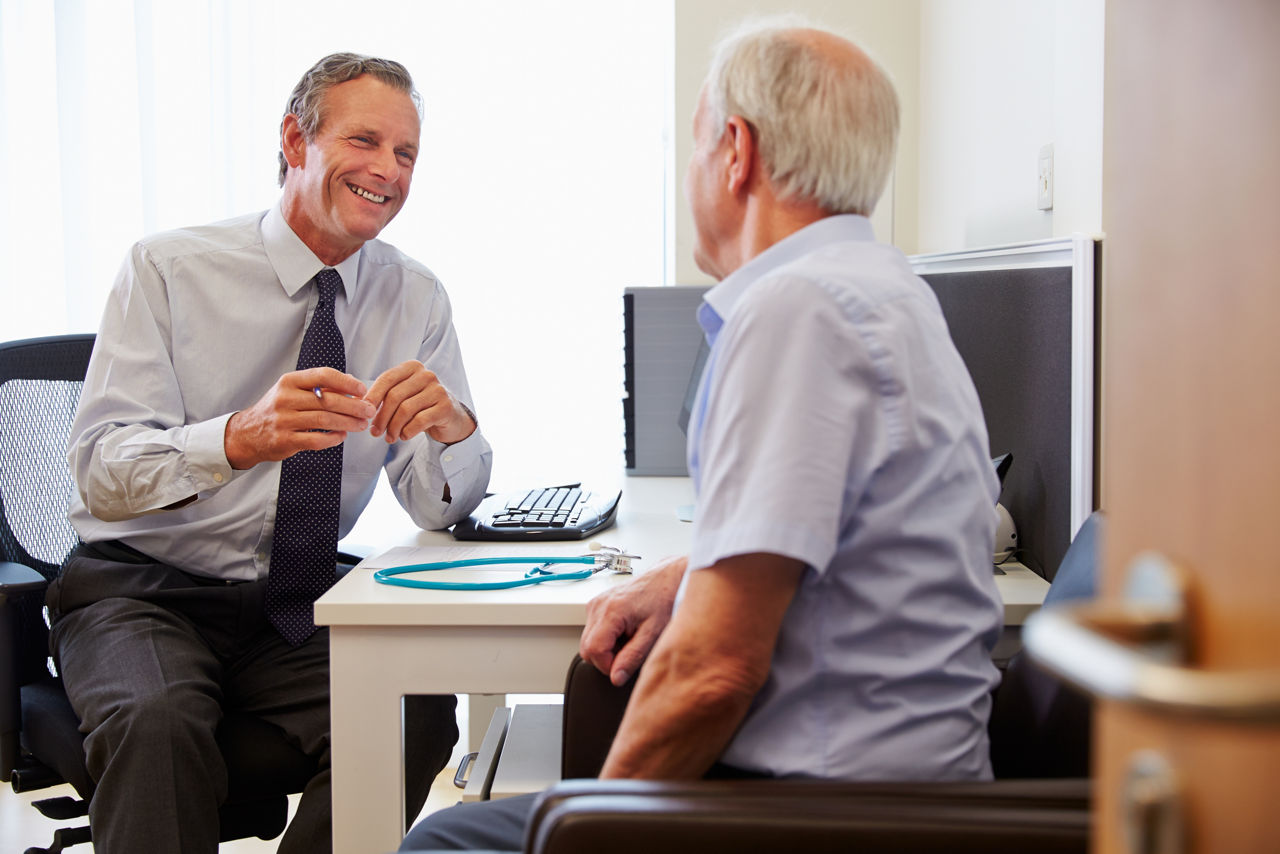 GP talking with elderly man