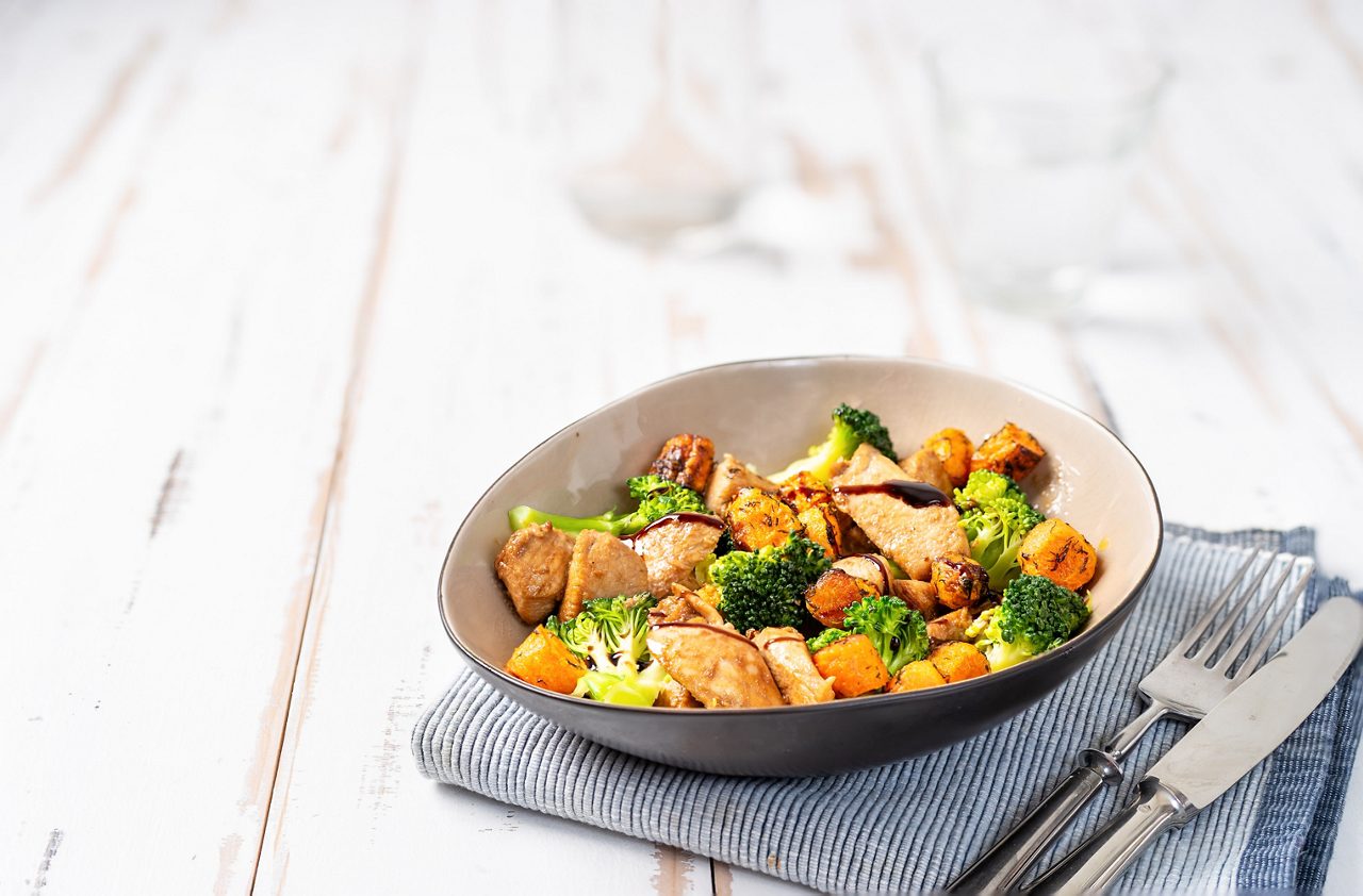 Healthy salad with chicken breast, broccoli and roasted carrots. Close up.