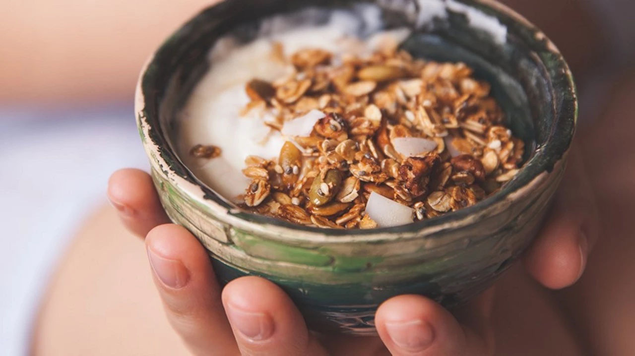 Hand holding yoghurt bowl