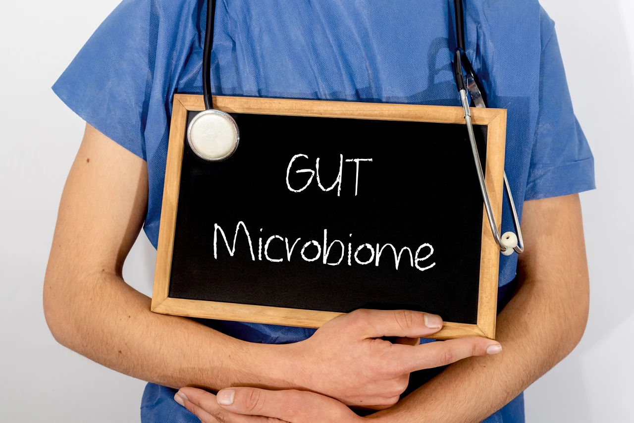 Nurse holding a Gut Microbiome small blackboard