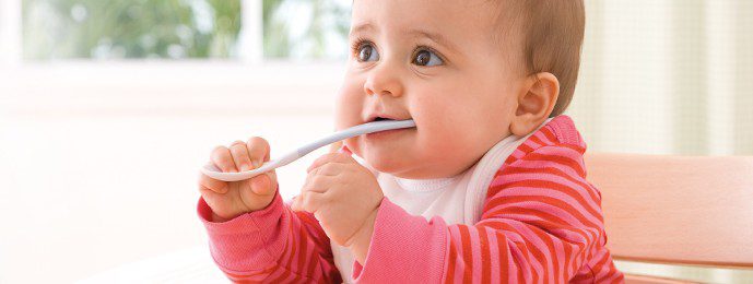 Baby with spoon in mouth