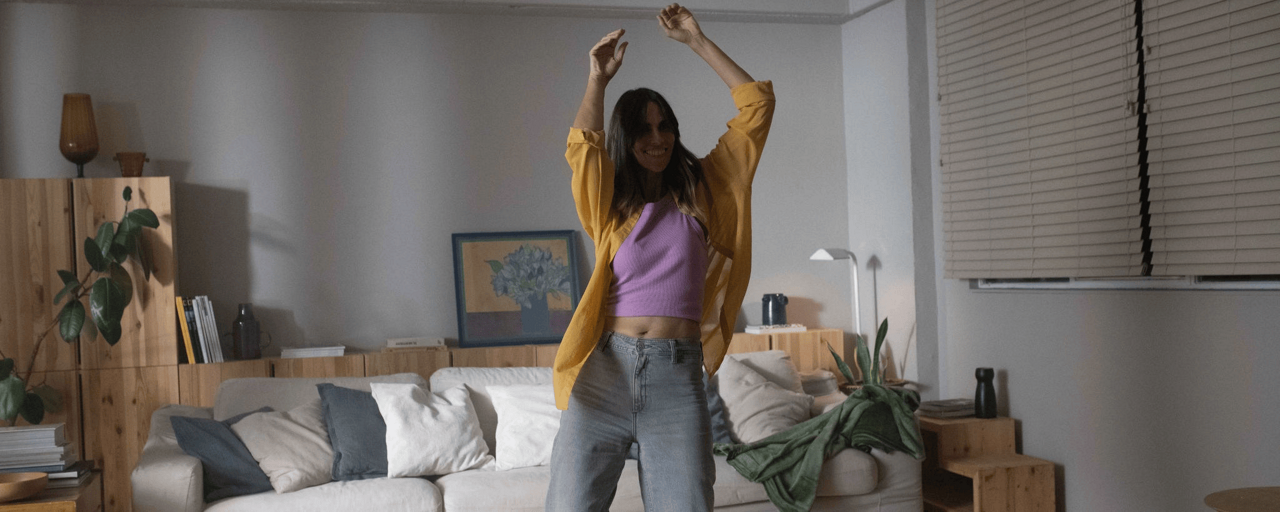 woment densing in livingroom