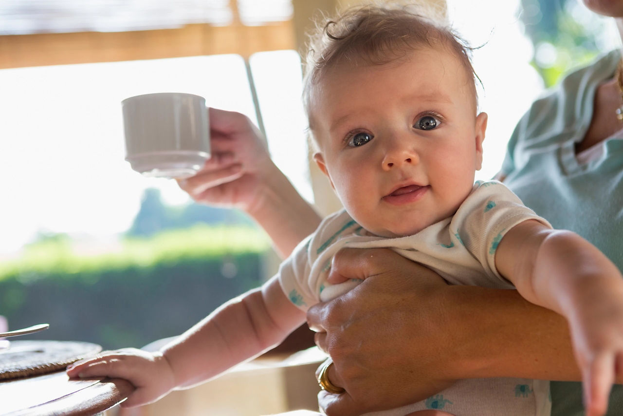 holding-baby-and-coffee