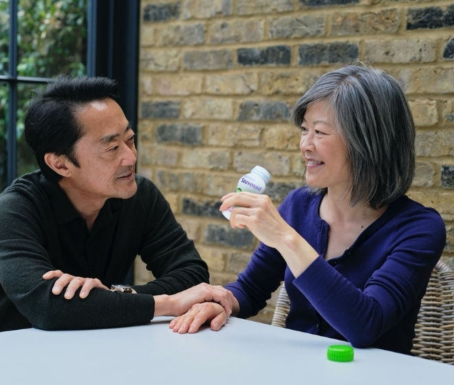 Man and woman sitting a table drinking souvenaid