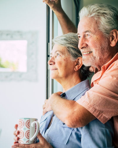 Senior couple looking out of a window