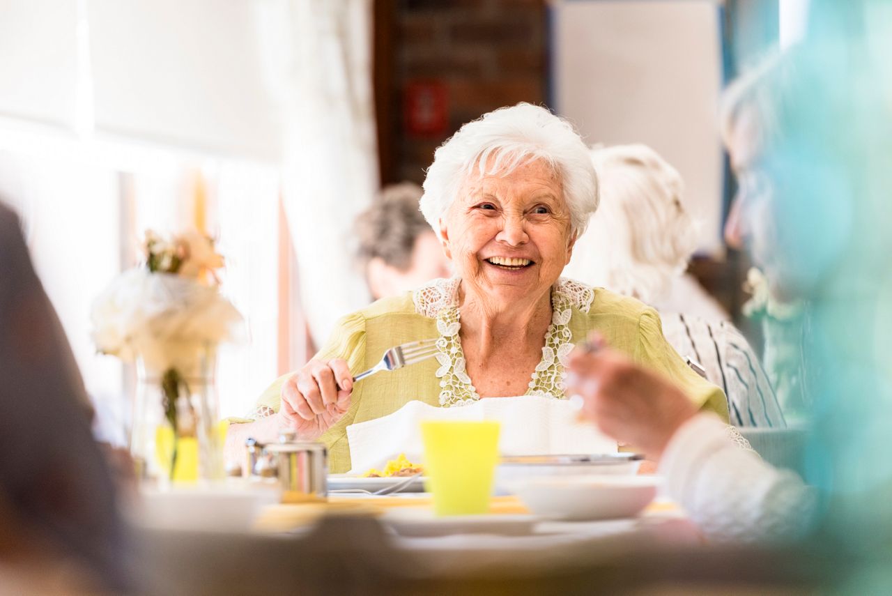 Portrait photo of a senior woman having lunch