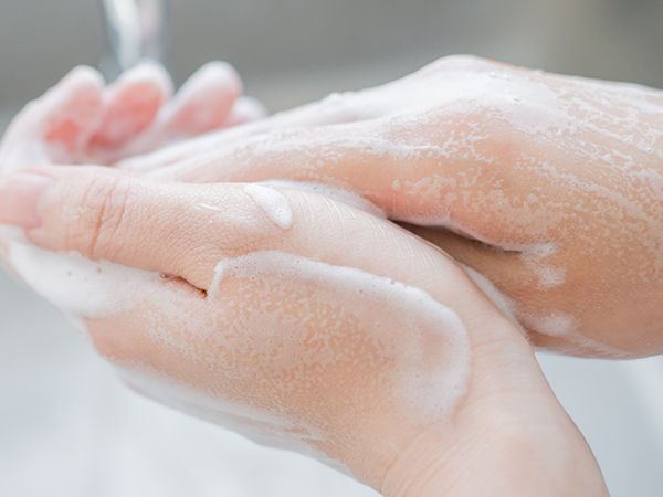 Woman washing her hands.