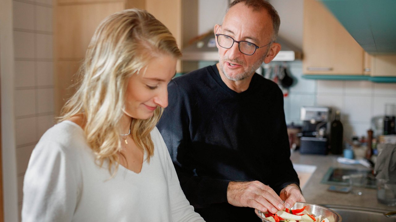man cooking with a woman in the kitchen 