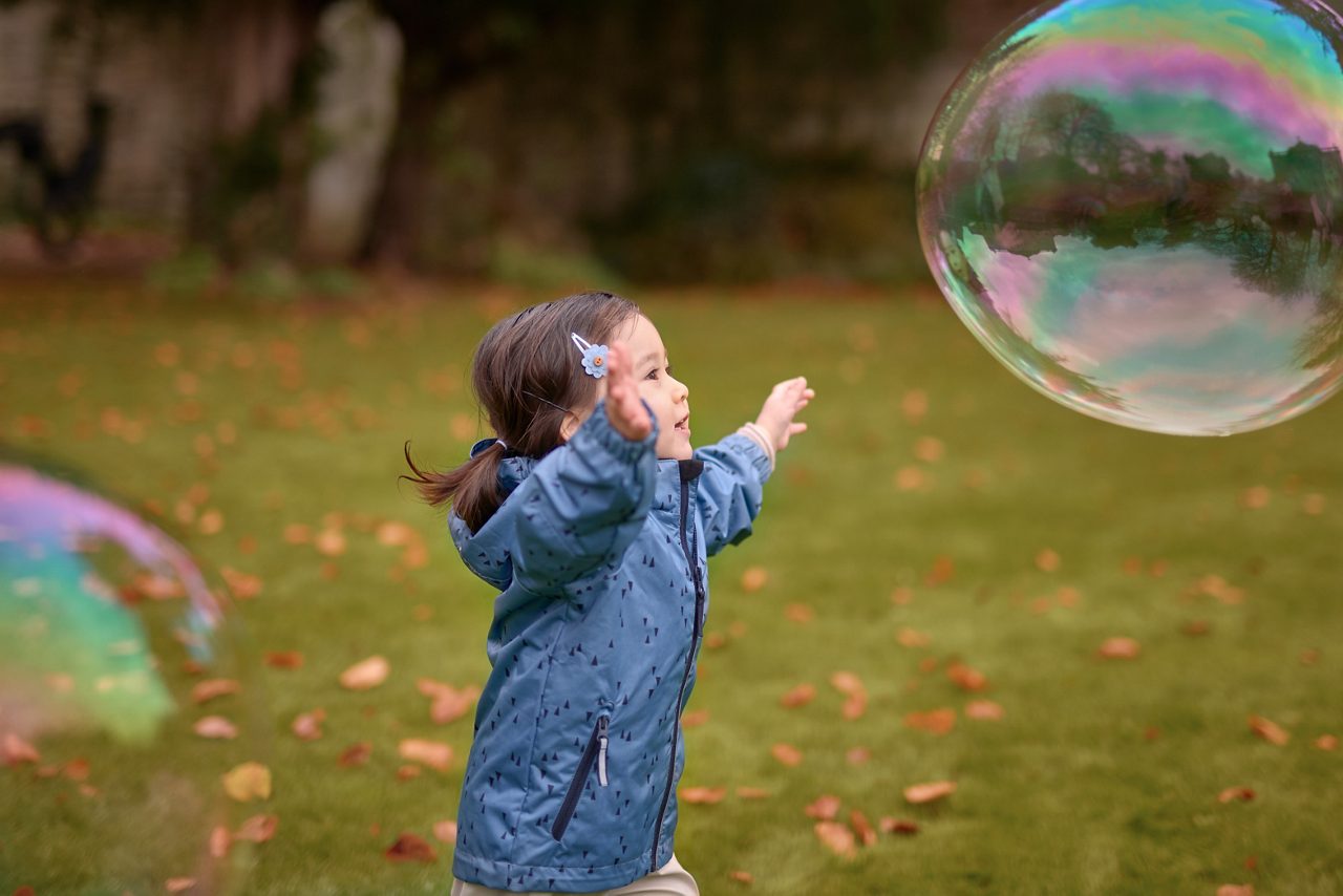 kid playing with bubbles