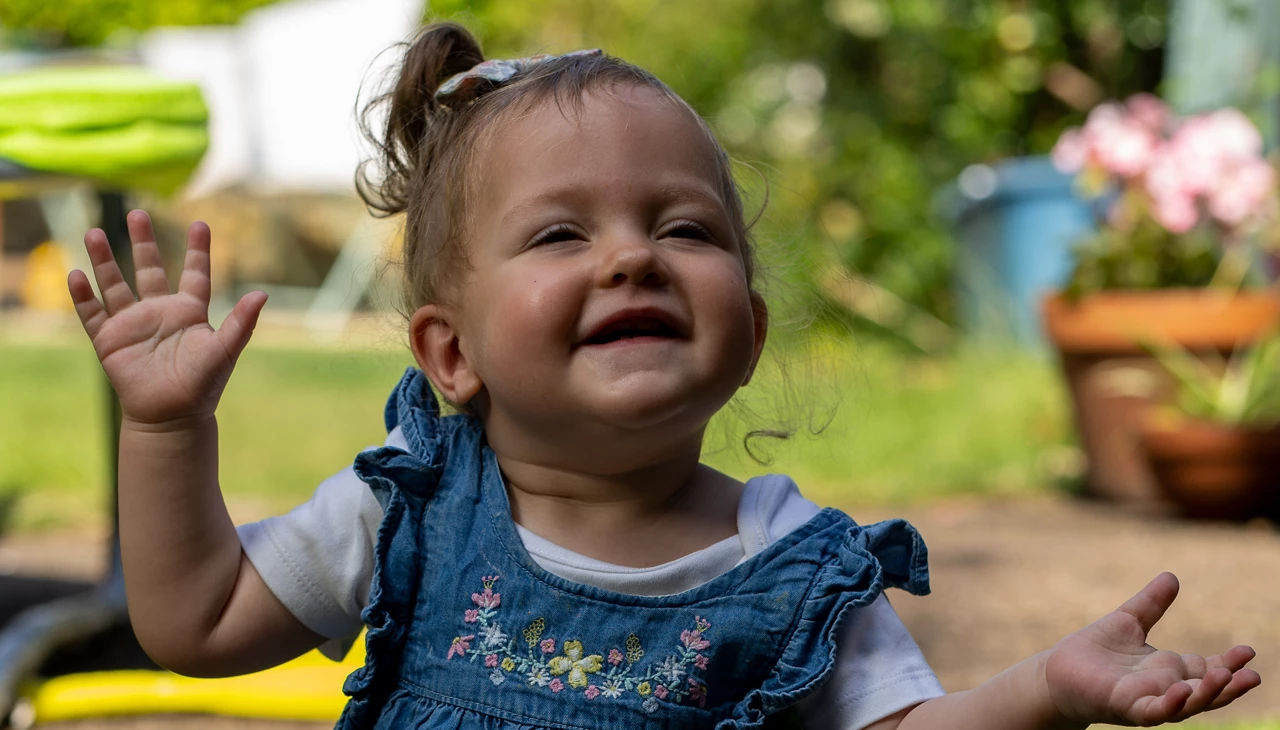 Little girl smiling in the garden