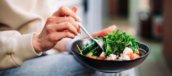 A woman in a wheelchair holding hands with a doctor
