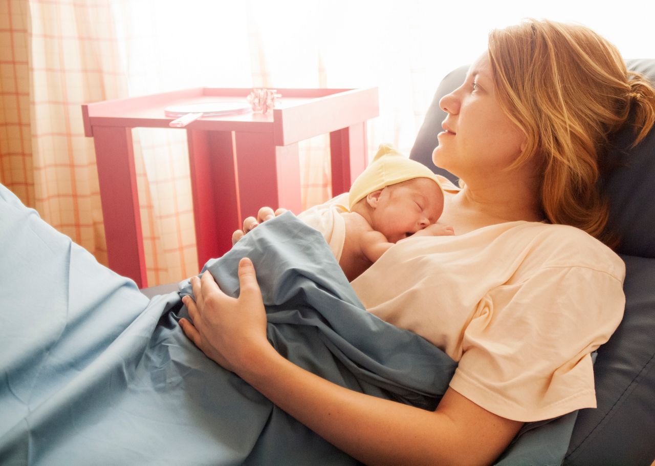 Premature baby born at 25th week of pregnancy sleeping during the kangaroo care session in hospital. Genuine emotions, real scene. Natural light.